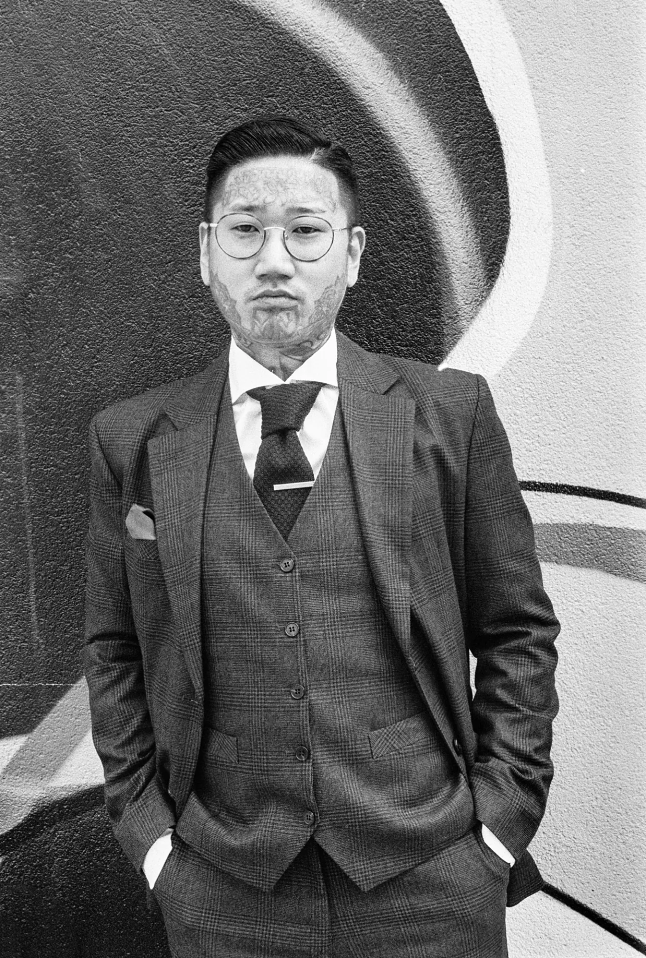 Portrait of a man wearing glasses and a suit