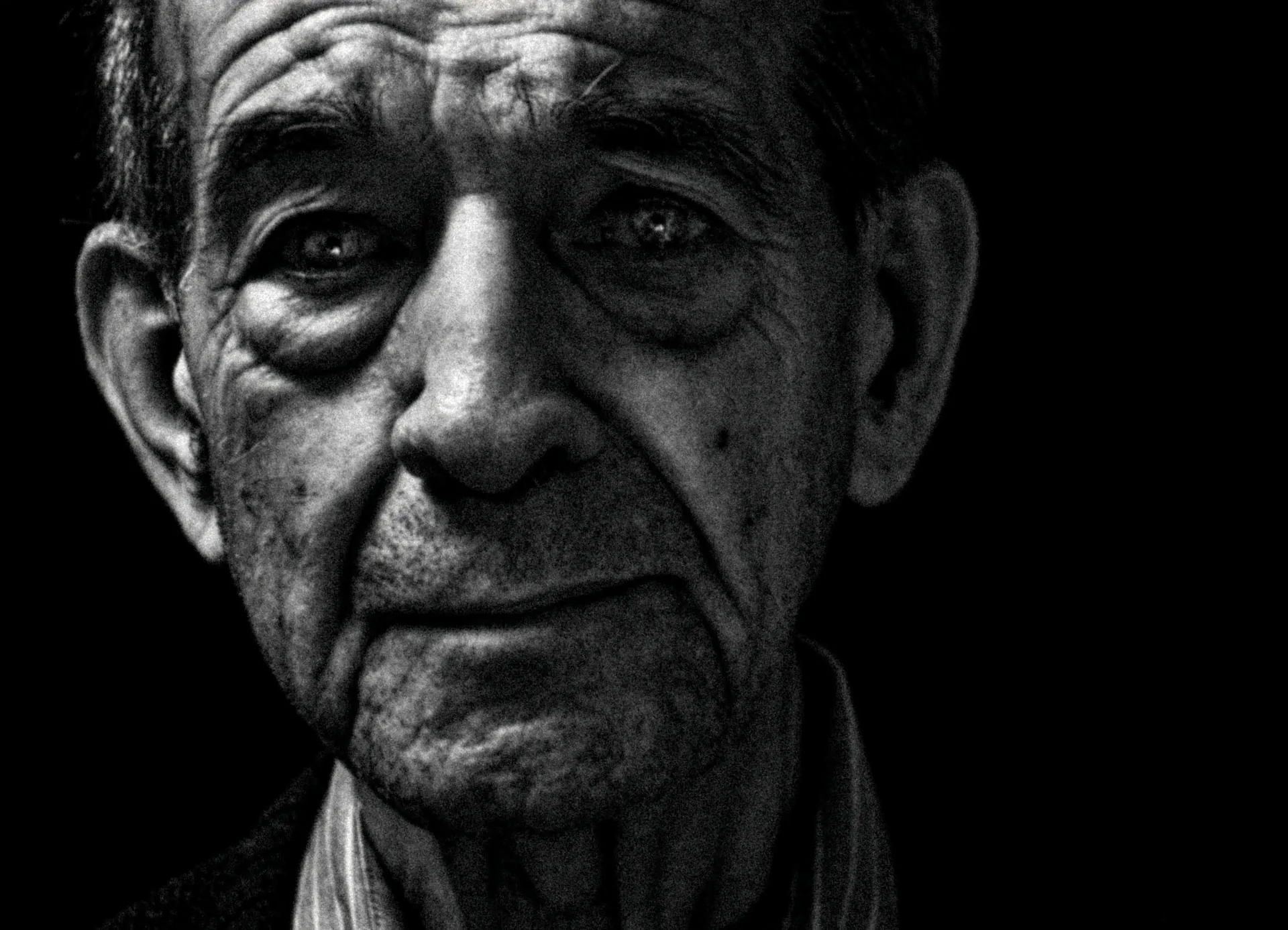 Close-up portrait of an elderly man's weathered face